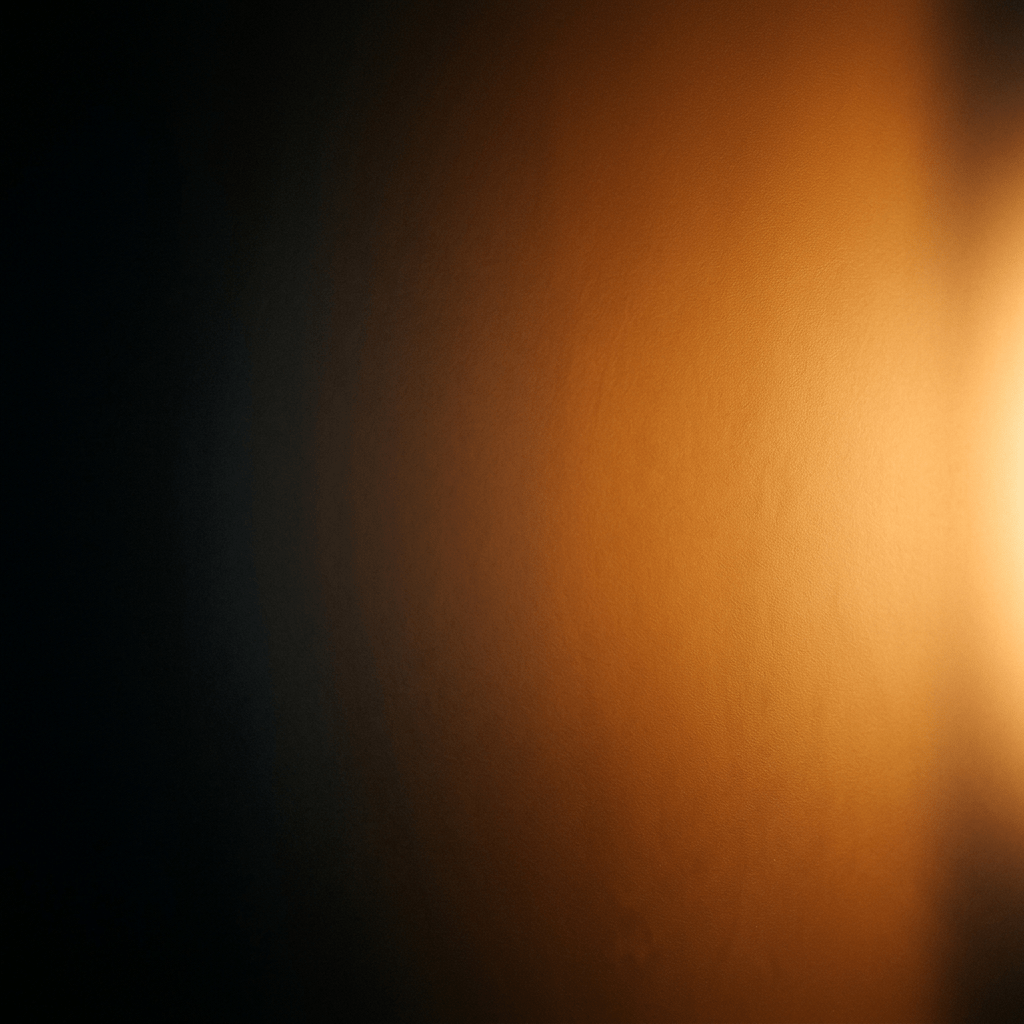 Smooth gradient of dark shadow transitioning to warm orange light